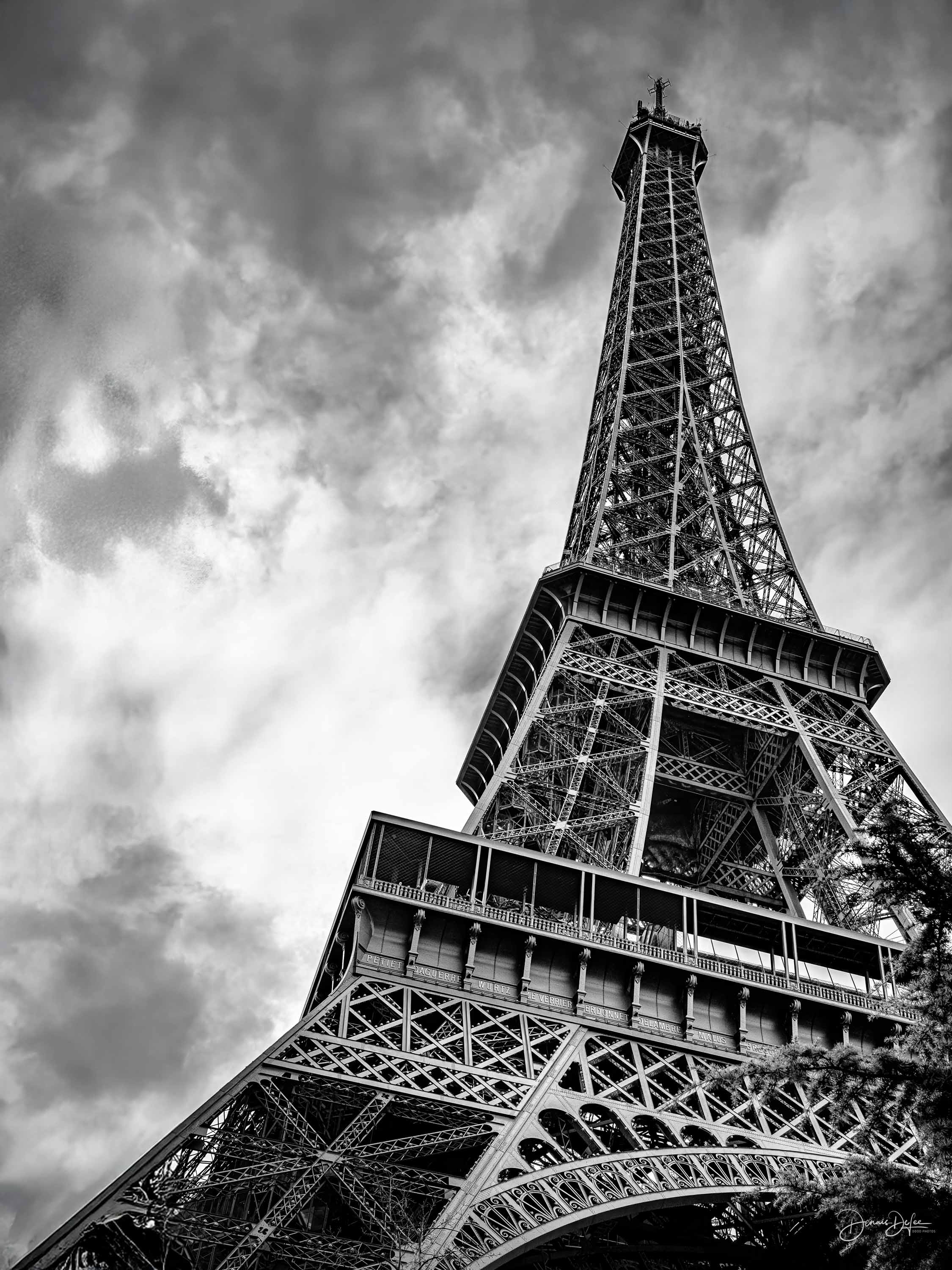 Eiffel Tower looking up at the iron structure, black and white