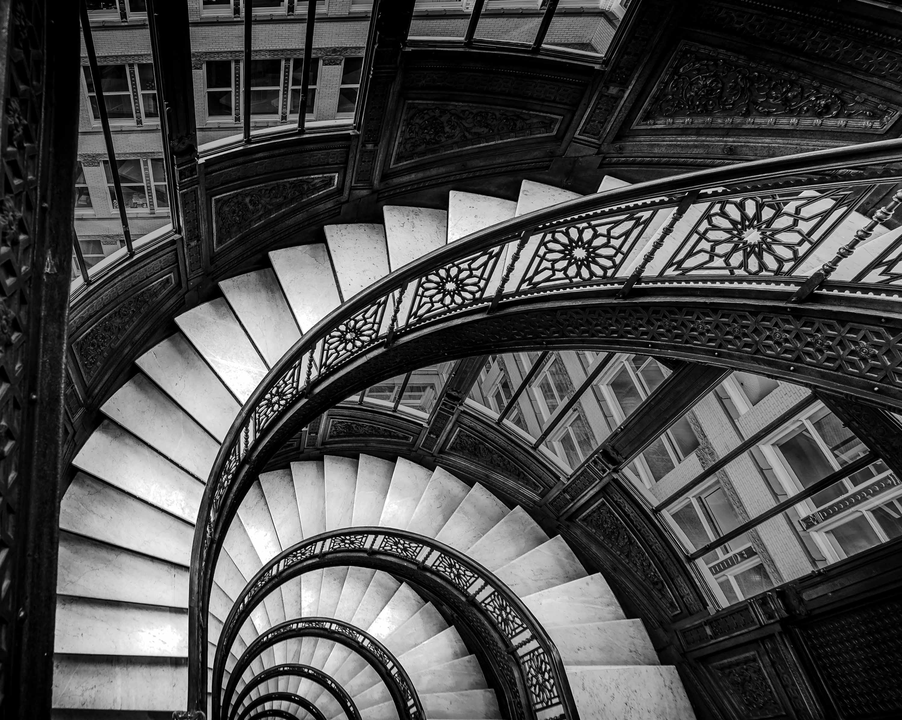 The Rookery Building's oriel staircase spiraling downward, black and white